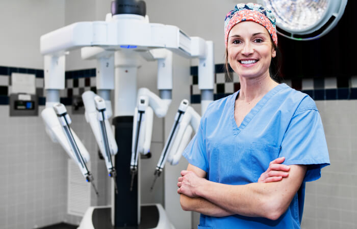 doctor standing in front of the da Vinci machine 