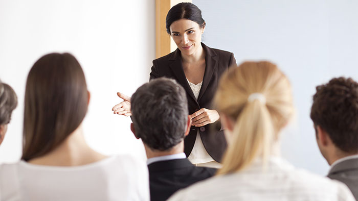 Professional woman leading a group of other professionals