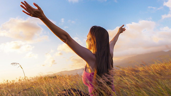 Carefree woman in a field of wheat