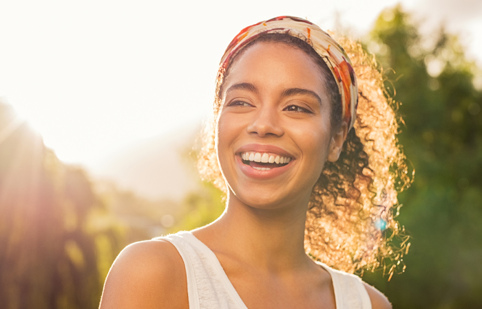 young black woman smiling and looking off into the distance