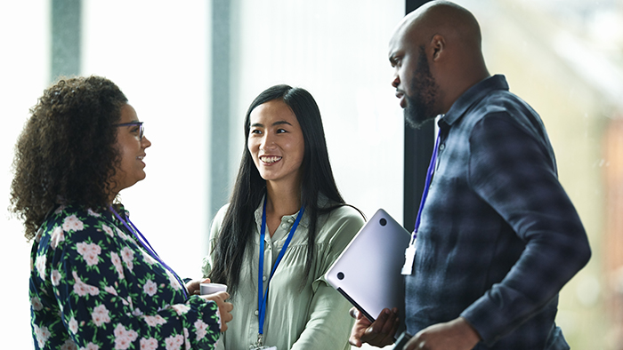 two women and one man speaking together