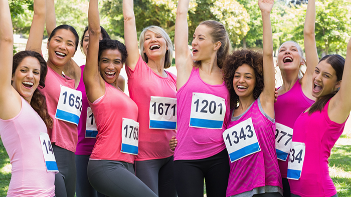 Several women celebrating dressed in pink running wear