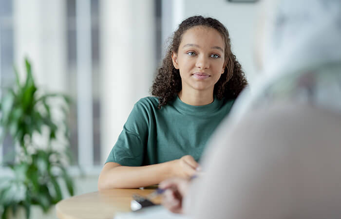 young black teen girl looking at provider off to the side