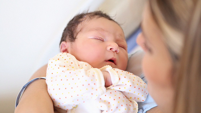 Infant baby in mom's arms