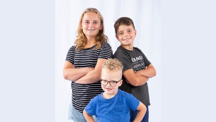 Three young girls with arms around each other