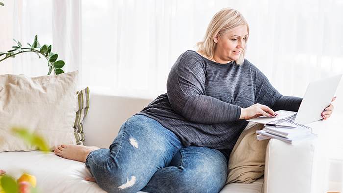 Woman on couch with laptop
