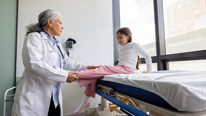 doctor checking young girls leg