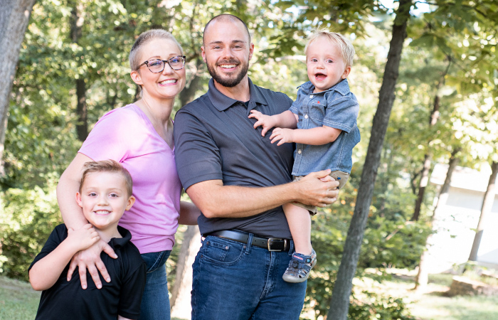 mother with cancer and husband holding two young male children