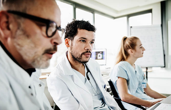 group of physicians listening to an educational presentation