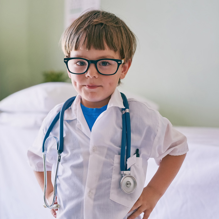 A young boy wearing a doctor's costume
