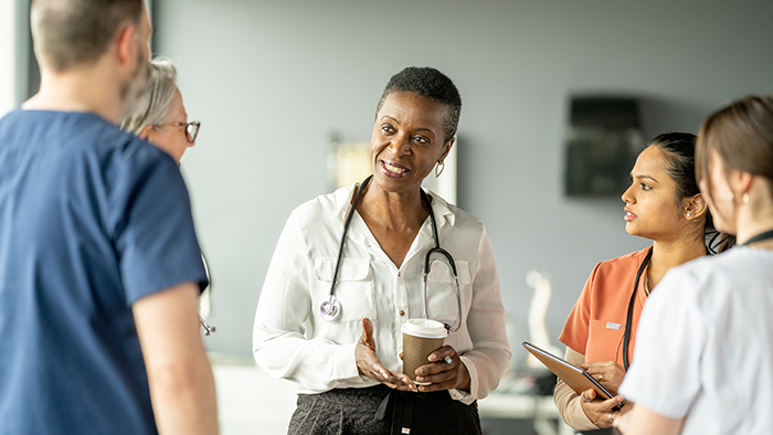 doctor talking with group of nurses