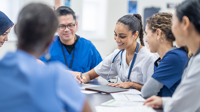 Small group of nursing students working at table