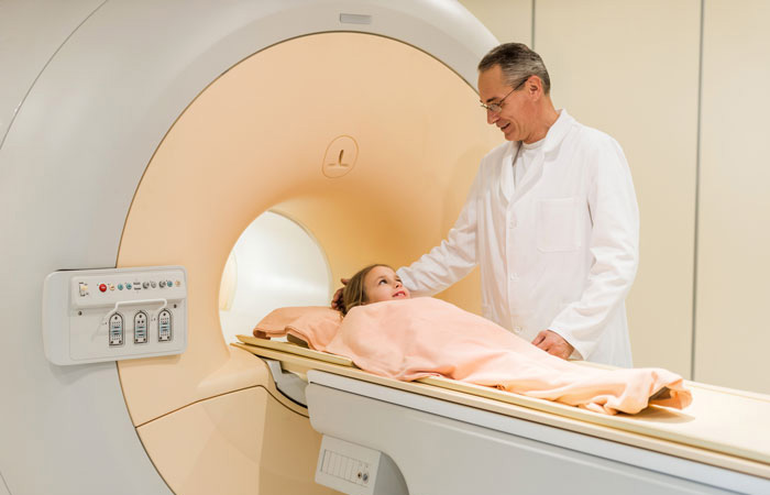 A cardiologist and a CNA giving a mature male a blood pressure screening