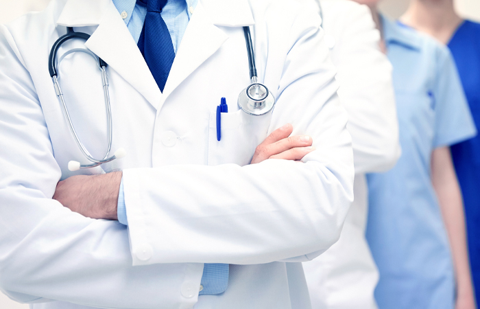 Group of doctors in lab coats and scrubs