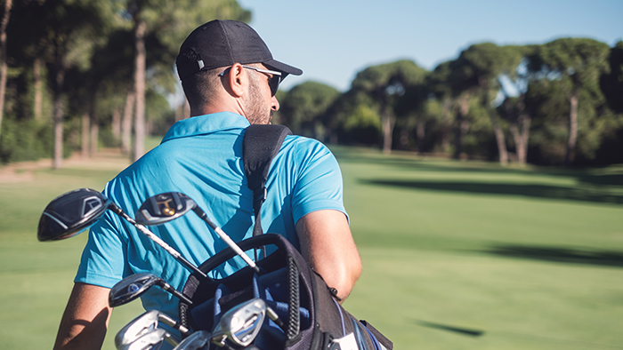 Man golfer walking the course