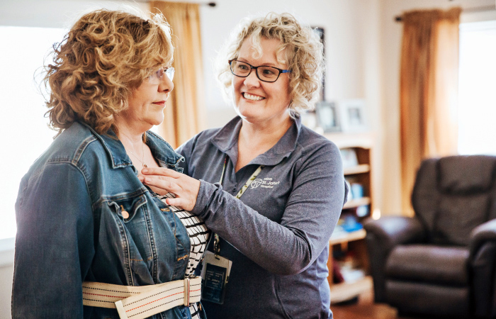 Female home care nurse helping out female patient with home therapy