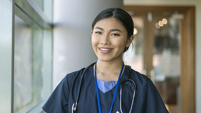 Young confident nurse wearing blue scrubs