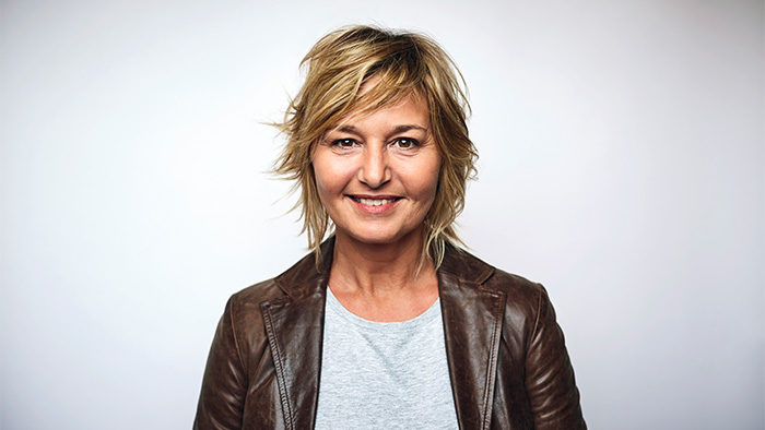 Middle-aged woman in a jacket.