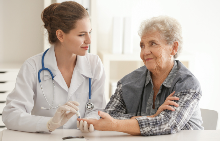 Female dietitian assisting older female patient with diabetes