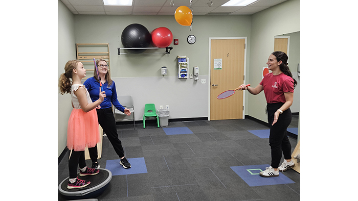 Rose Borries and Avery Pacella work with Emmie Sidwell