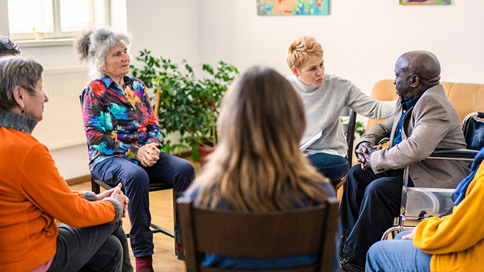 A diverse group of people in a support group