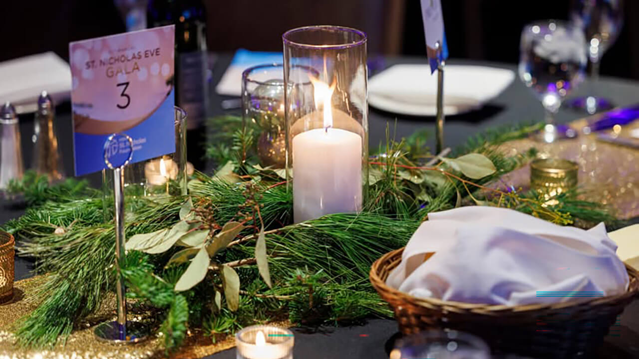 A table with a candle at the St. Nicholas Gala
