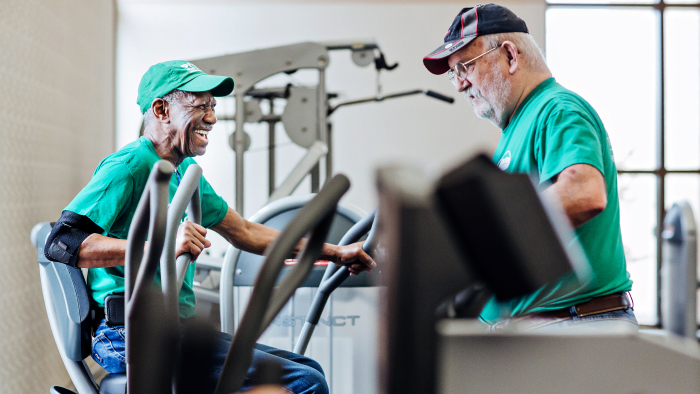 Two older men working out on gym-type equipment
