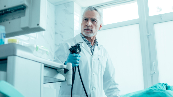 Surgeon concentrating on equipment