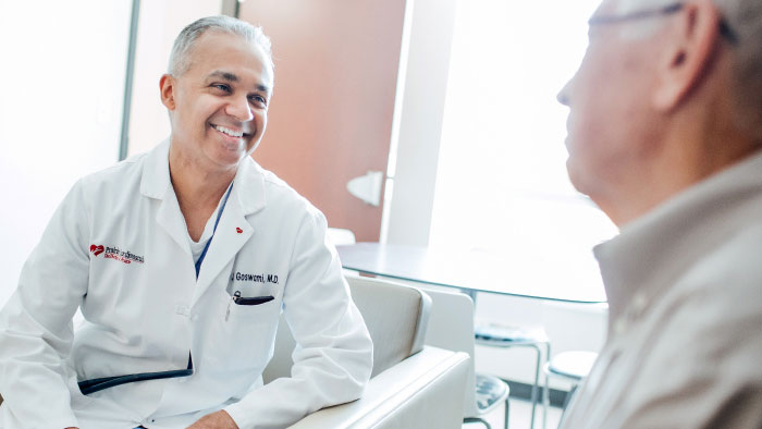 A cardiologist speaking with a male patient