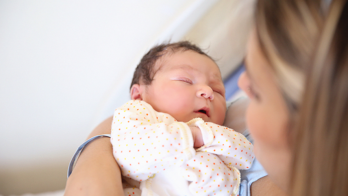 Infant baby in mom's arms