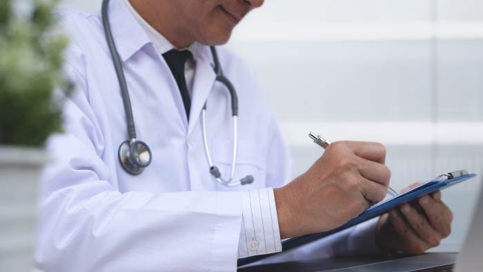 Doctor in white coat with a clipboard