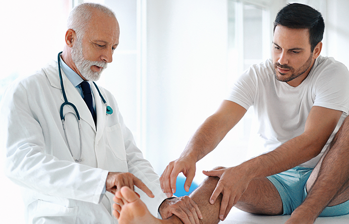 Doctor working with patient on ankle