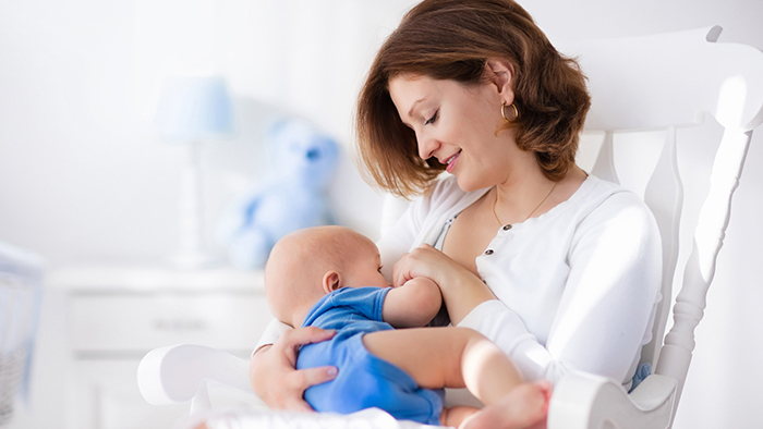 New mom breastfeeding her baby boy