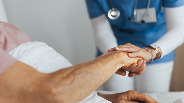 nurse holding patients hand