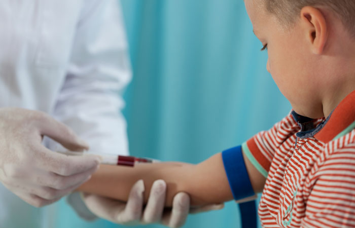 young child receiving blood draw