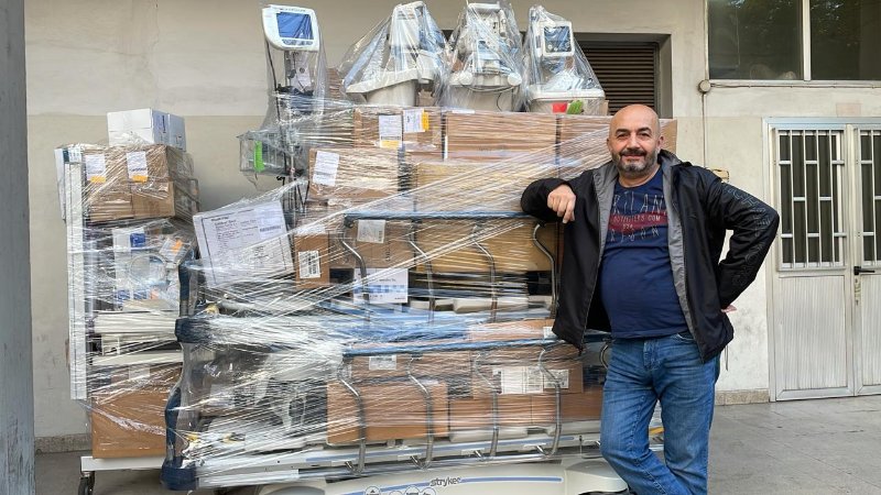 Man in front of medical supplies and equipment
